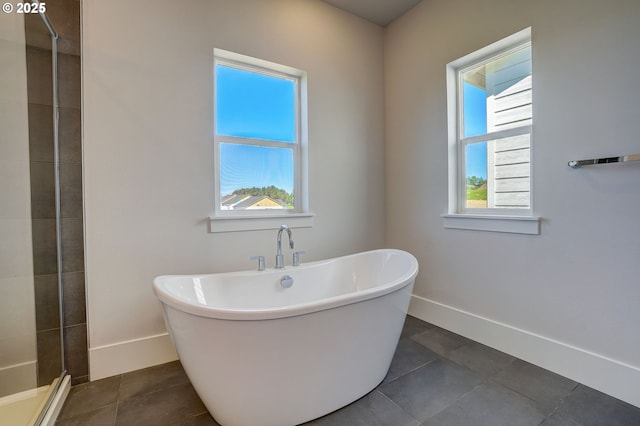 17955 SW Howlock Ln, Beaverton, OR 97007 - full bathroom featuring a tile shower, a freestanding bath, baseboards, and tile patterned flooring