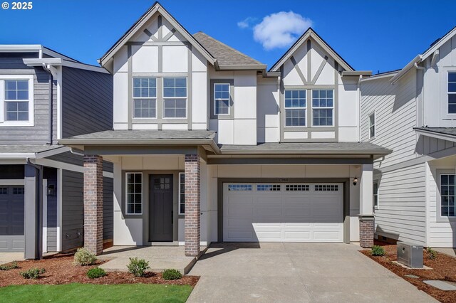 17955 SW Howlock Ln, Beaverton, OR 97007 - view of front of property with stucco siding, an attached garage, driveway, and roof with shingles