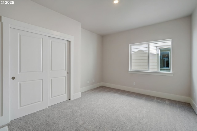 17955 SW Howlock Ln, Beaverton, OR 97007 - unfurnished bedroom with carpet floors, baseboards, and a closet