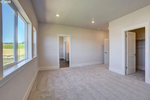 17955 SW Howlock Ln, Beaverton, OR 97007 - unfurnished bedroom with carpet floors, a spacious closet, recessed lighting, baseboards, and a closet