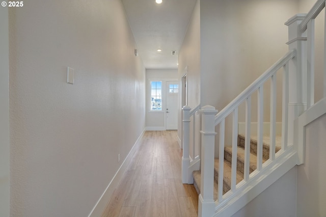 17955 SW Howlock Ln, Beaverton, OR 97007 - hallway with stairway, light wood finished floors, recessed lighting, and baseboards