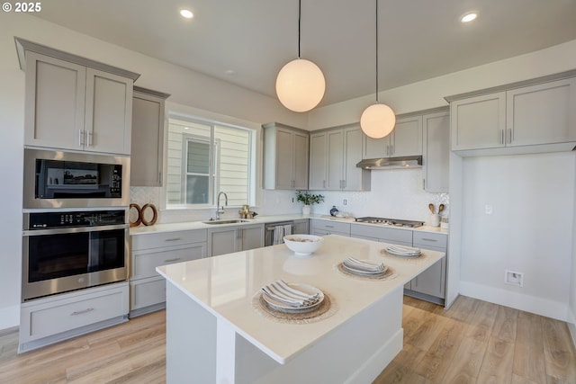 17955 SW Howlock Ln, Beaverton, OR 97007 - kitchen with stainless steel appliances, gray cabinetry, a sink, tasteful backsplash, and light countertops