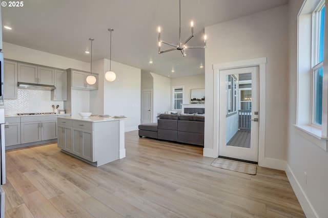 17955 SW Howlock Ln, Beaverton, OR 97007 - kitchen featuring gray cabinetry, stainless steel gas cooktop, backsplash, a chandelier, and recessed lighting