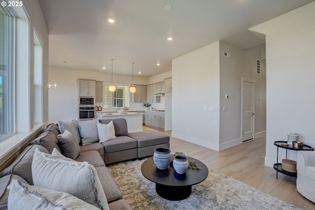 17955 SW Howlock Ln, Beaverton, OR 97007 - living room featuring light wood-style flooring, recessed lighting, and baseboards
