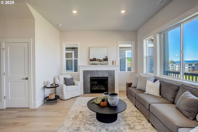 17955 SW Howlock Ln, Beaverton, OR 97007 - living area with light wood-type flooring, baseboards, a fireplace, and recessed lighting