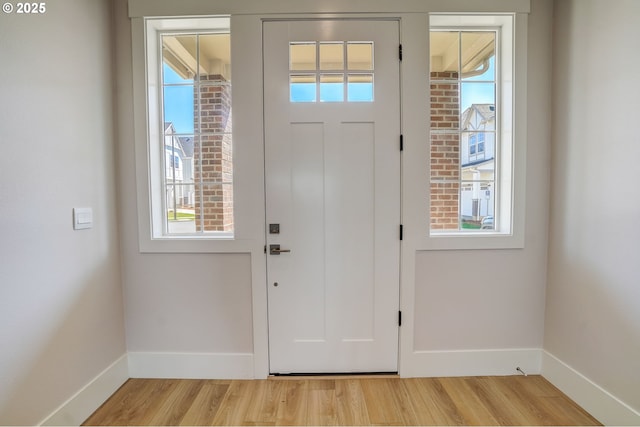 17955 SW Howlock Ln, Beaverton, OR 97007 - foyer with baseboards, plenty of natural light, and light wood-style floors
