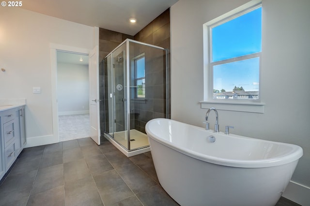17955 SW Howlock Ln, Beaverton, OR 97007 - full bathroom featuring vanity, a shower stall, a soaking tub, tile patterned flooring, and recessed lighting
