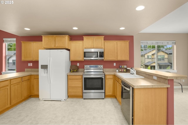 1544 SW 175th Ave, Beaverton, OR 97003 - kitchen with stainless steel appliances, a peninsula, a sink, healthy amount of natural light, and recessed lighting