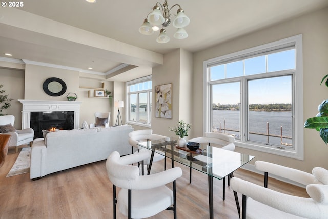 707 N Hayden Island Dr Unit 415, Portland, OR 97217 - living area with light wood finished floors, a chandelier, a tiled fireplace, a water view, and recessed lighting