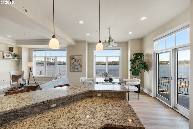 707 N Hayden Island Dr Unit 415, Portland, OR 97217 - kitchen featuring plenty of natural light, a water view, light wood-style floors, recessed lighting, and a chandelier