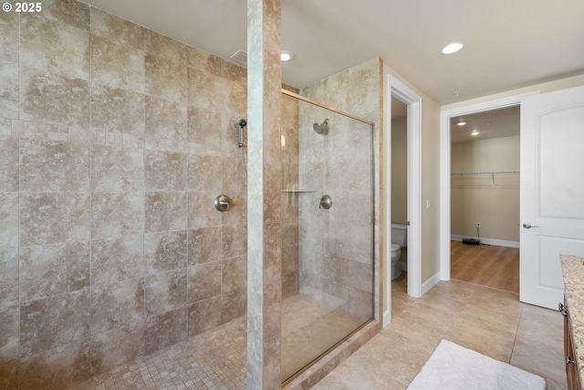 707 N Hayden Island Dr Unit 415, Portland, OR 97217 - bathroom featuring a shower stall, recessed lighting, tile patterned floors, and a spacious closet