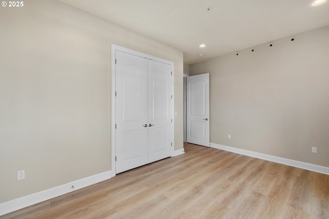 707 N Hayden Island Dr Unit 415, Portland, OR 97217 - unfurnished bedroom featuring recessed lighting, light wood-style floors, and a closet