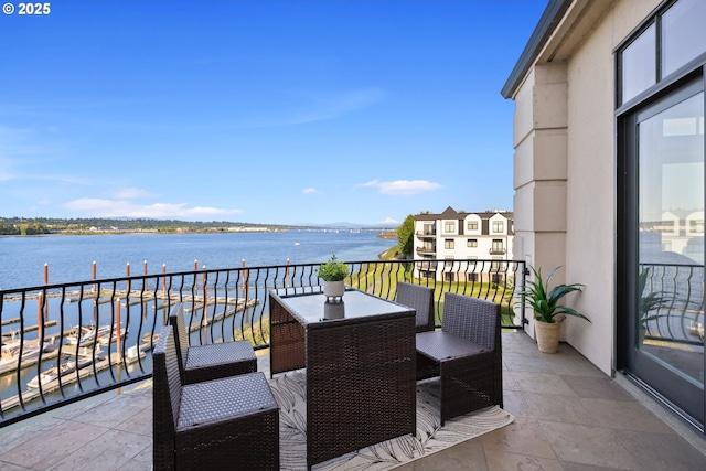 707 N Hayden Island Dr Unit 415, Portland, OR 97217 - balcony with a water view and outdoor dining space