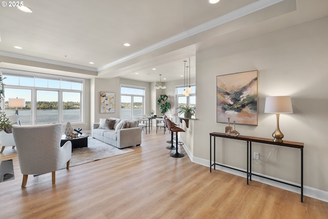 707 N Hayden Island Dr Unit 415, Portland, OR 97217 - living room with ornamental molding, wood finished floors, recessed lighting, a tray ceiling, and a chandelier