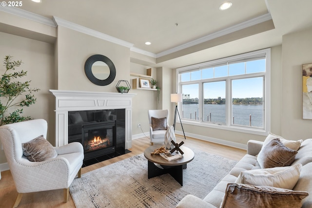 707 N Hayden Island Dr Unit 415, Portland, OR 97217 - living room with a fireplace with flush hearth, light wood-style floors, crown molding, recessed lighting, and a water view