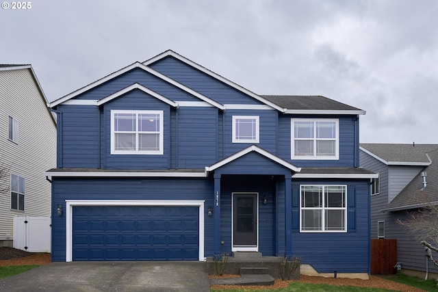 traditional-style home featuring driveway and an attached garage