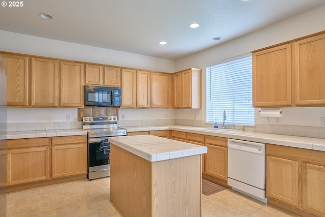 kitchen featuring stainless steel range with electric stovetop, black microwave, white dishwasher, tile countertops, and a sink
