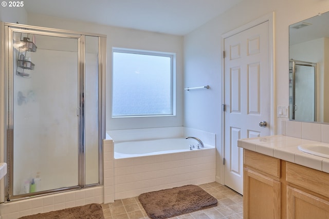 full bathroom with a garden tub, tile patterned flooring, visible vents, vanity, and a stall shower