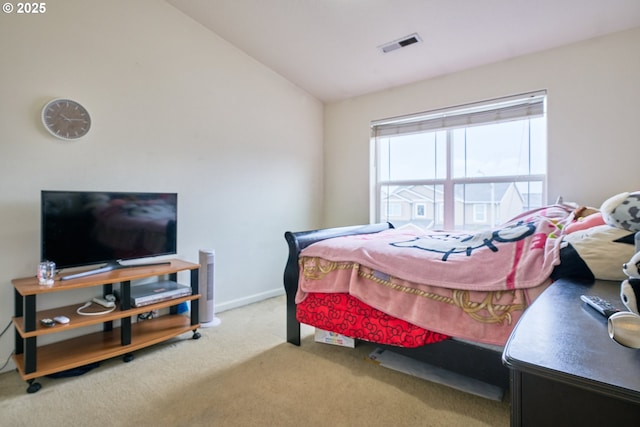 carpeted bedroom with baseboards, visible vents, and vaulted ceiling