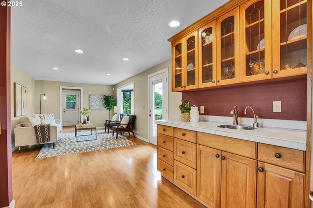 3270 N Maple St, Canby, OR 97013 - kitchen featuring a sink, light wood-style floors, open floor plan, recessed lighting, and a textured ceiling