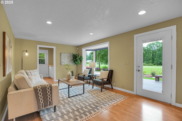 3270 N Maple St, Canby, OR 97013 - living area featuring a textured ceiling, wood finished floors, baseboards, and recessed lighting