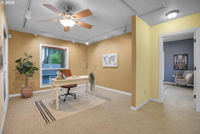 3270 N Maple St, Canby, OR 97013 - carpeted home office with rail lighting, a textured ceiling, a ceiling fan, and baseboards