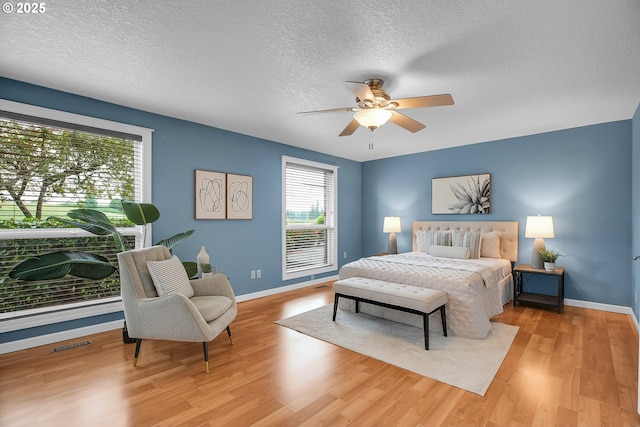 3270 N Maple St, Canby, OR 97013 - bedroom with a textured ceiling, wood finished floors, baseboards, and ceiling fan