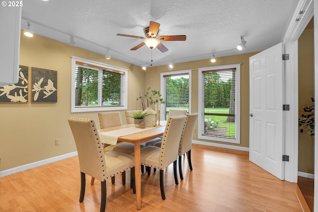 3270 N Maple St, Canby, OR 97013 - dining space with track lighting, a ceiling fan, light wood-style flooring, baseboards, and a textured ceiling