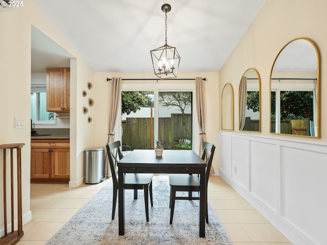 dining room with light tile patterned floors, an inviting chandelier, and a wealth of natural light