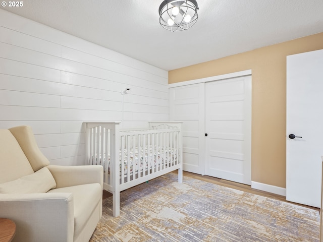 bedroom with baseboards, a closet, and wood finished floors
