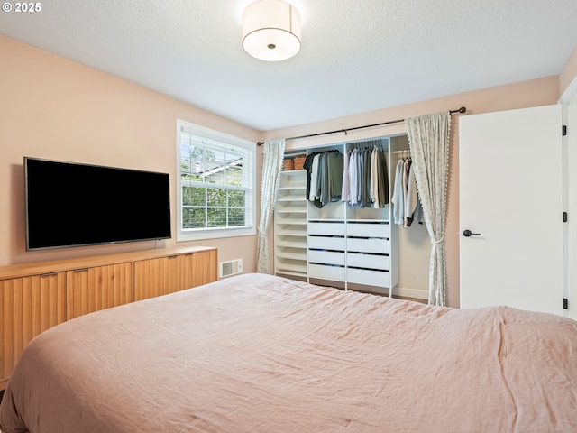 bedroom featuring a closet and visible vents