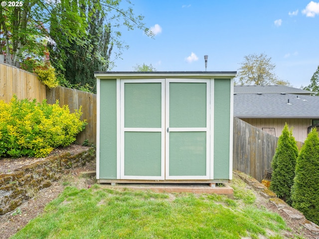 view of shed with a fenced backyard
