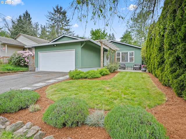 single story home with an attached garage, a front lawn, and aphalt driveway