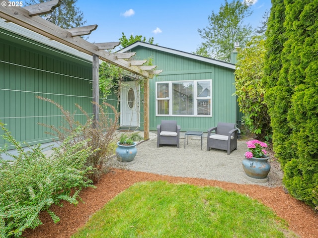 back of property featuring a pergola and a patio area