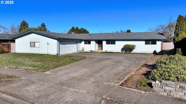 ranch-style house with a garage and a front lawn