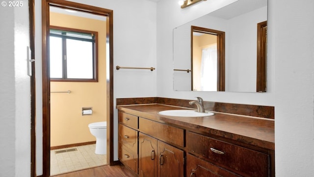 bathroom with vanity and toilet