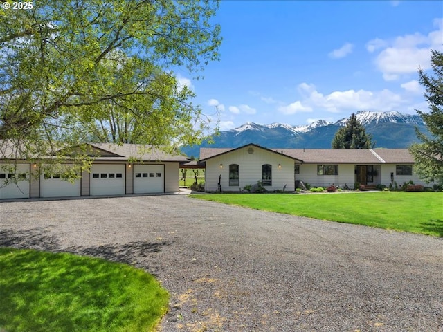 65155 Hurricane Creek Rd, Enterprise, OR 97828 - ranch-style house featuring a mountain view, an attached garage, driveway, and a front lawn