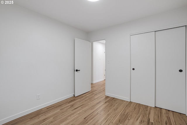 116 SE 153rd Ave, Portland, OR 97233 - unfurnished bedroom with light wood finished floors, baseboards, and a closet