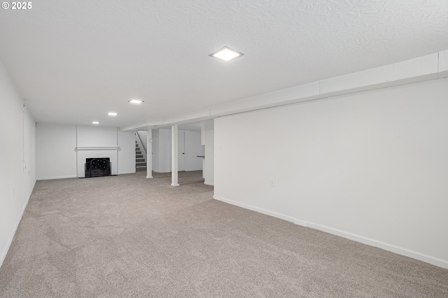 116 SE 153rd Ave, Portland, OR 97233 - finished below grade area featuring light colored carpet, baseboards, a brick fireplace, and recessed lighting