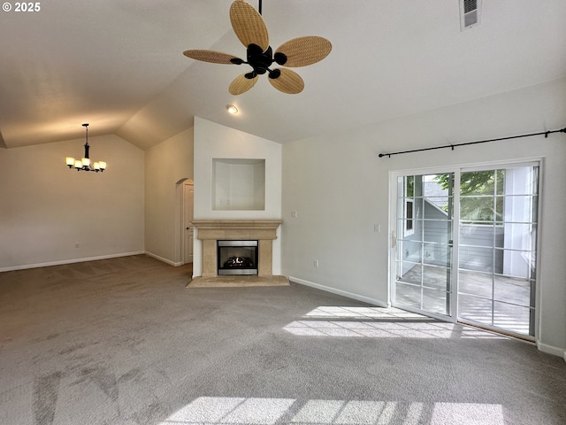 unfurnished living room featuring a fireplace, vaulted ceiling, carpet flooring, and visible vents