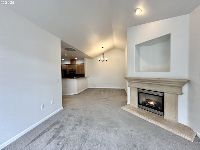 unfurnished living room featuring visible vents, a chandelier, a tile fireplace, carpet, and vaulted ceiling