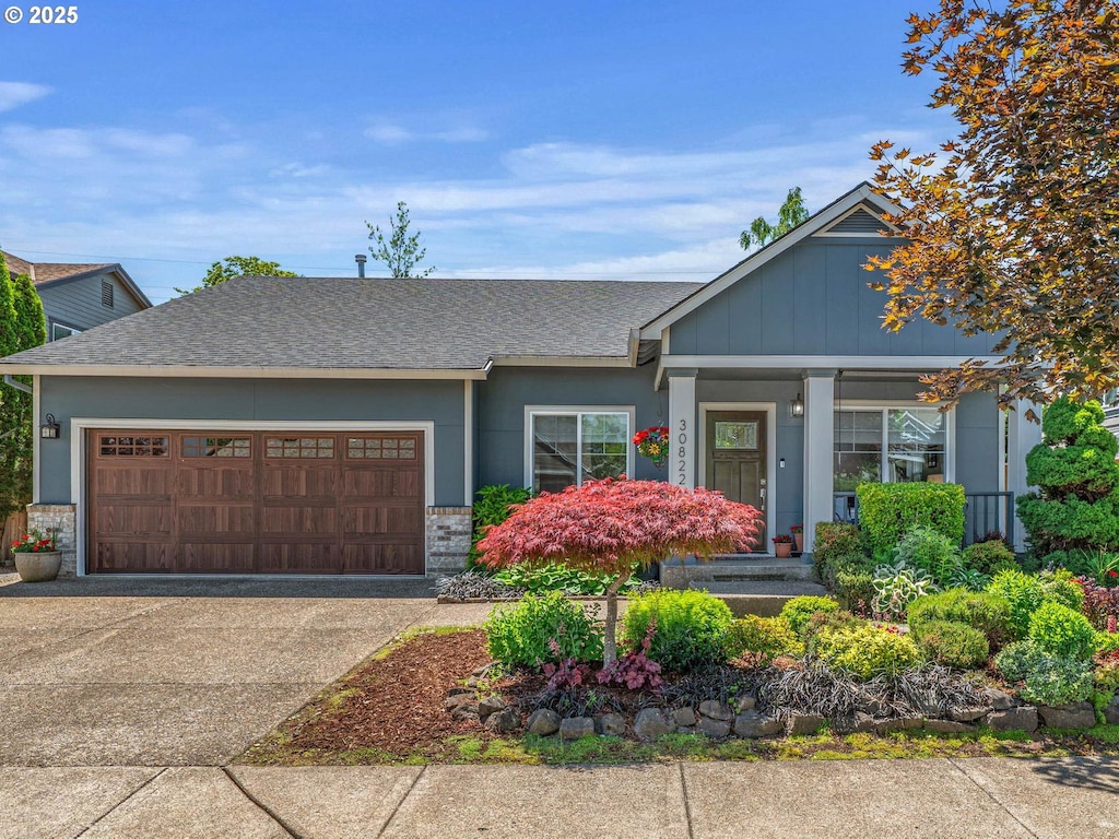 30822 NW Brooking Ct, North Plains, OR 97133 - view of front of property featuring a garage, brick siding, driveway, and roof with shingles