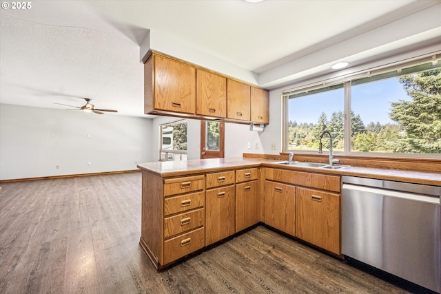 51945 SW Creekview Pl, Scappoose, OR 97056 - kitchen featuring stainless steel dishwasher, a sink, dark wood-type flooring, and a peninsula