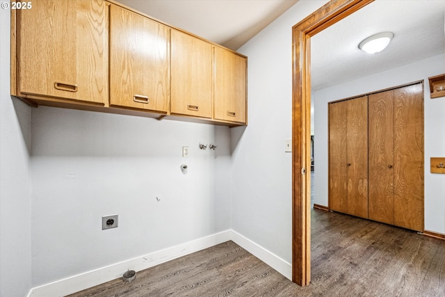 51945 SW Creekview Pl, Scappoose, OR 97056 - washroom featuring cabinet space, wood finished floors, hookup for an electric dryer, baseboards, and hookup for a gas dryer