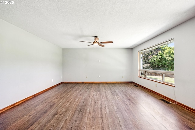 51945 SW Creekview Pl, Scappoose, OR 97056 - unfurnished room with wood finished floors, ceiling fan, baseboards, and a textured ceiling