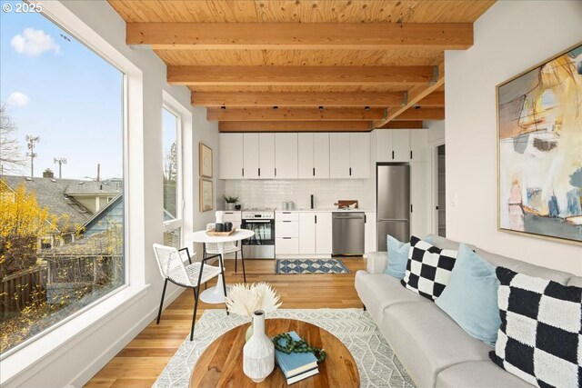 living area featuring wooden ceiling, beamed ceiling, and light wood-style flooring