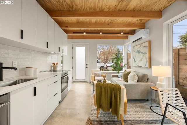 kitchen with a sink, stainless steel appliances, an AC wall unit, and wood ceiling