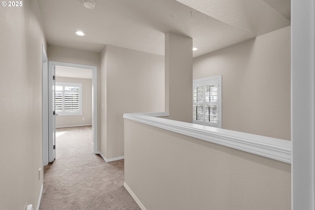 hall with light carpet, recessed lighting, and baseboards