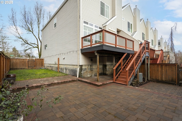 back of house featuring a patio, stairway, a wooden deck, and a fenced backyard