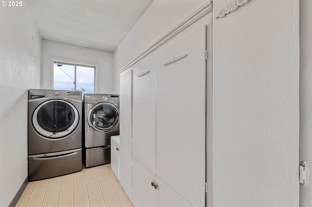 washroom featuring washing machine and clothes dryer and light tile patterned floors